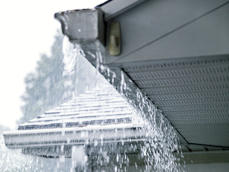 Water spilling over the gutter edges during rain